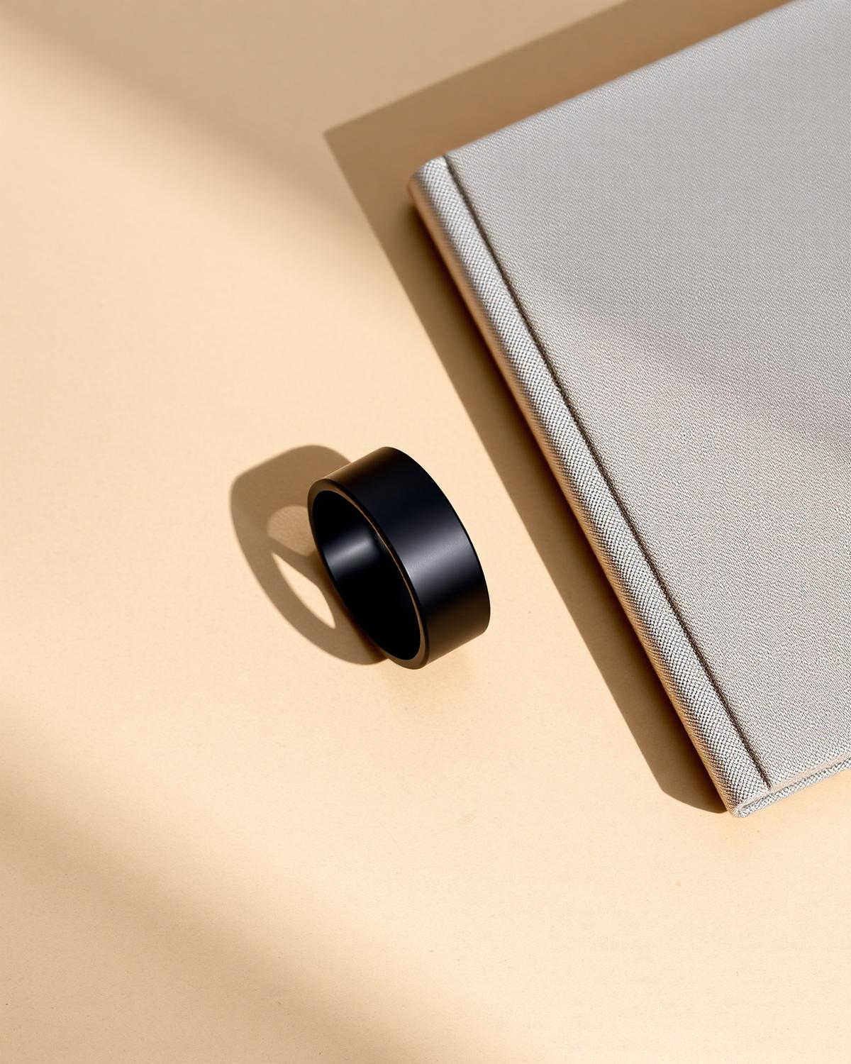 Minimal wellness setting with a wearable tracker, journal and natural light